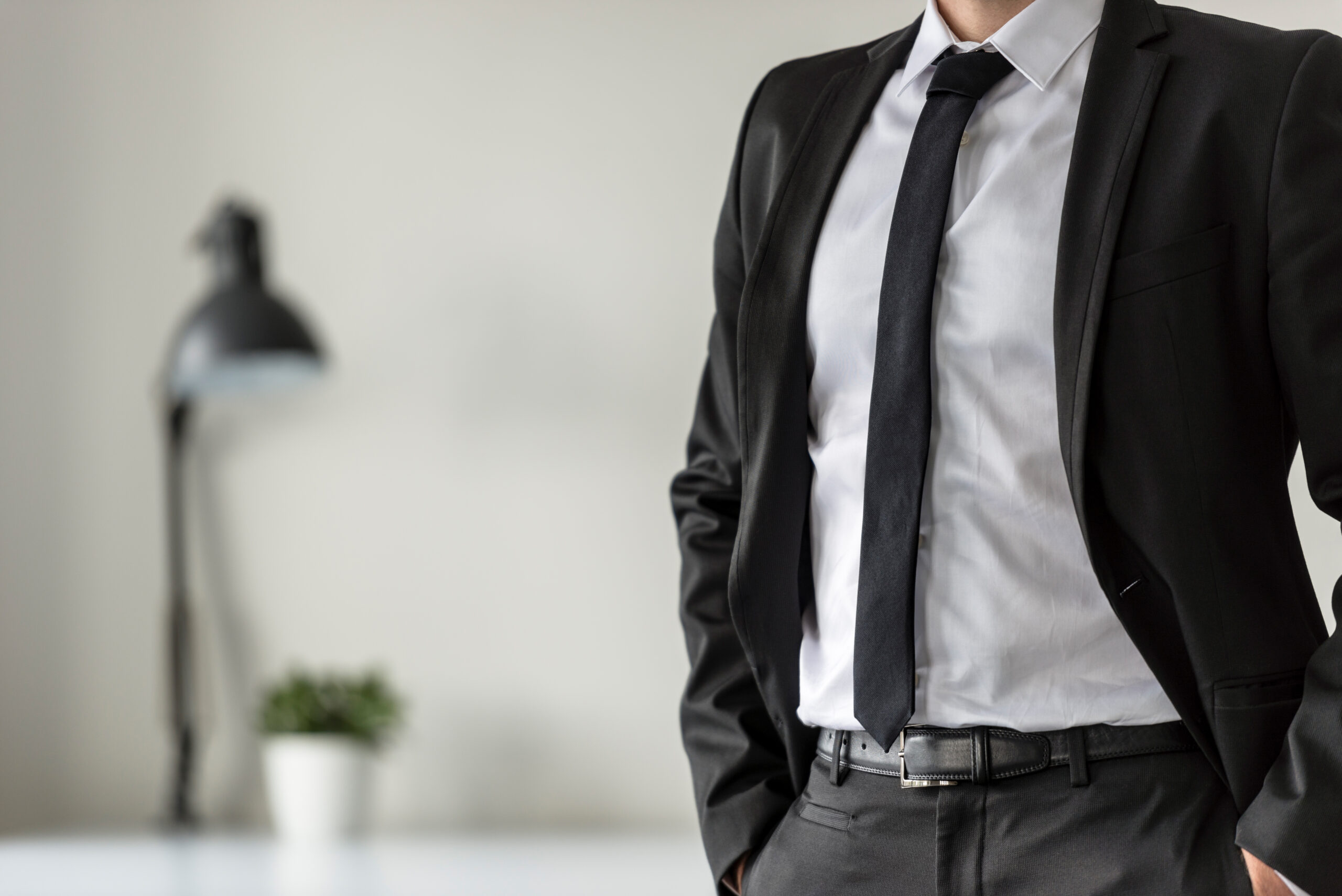 business man in his office with his hands in the pockets of his